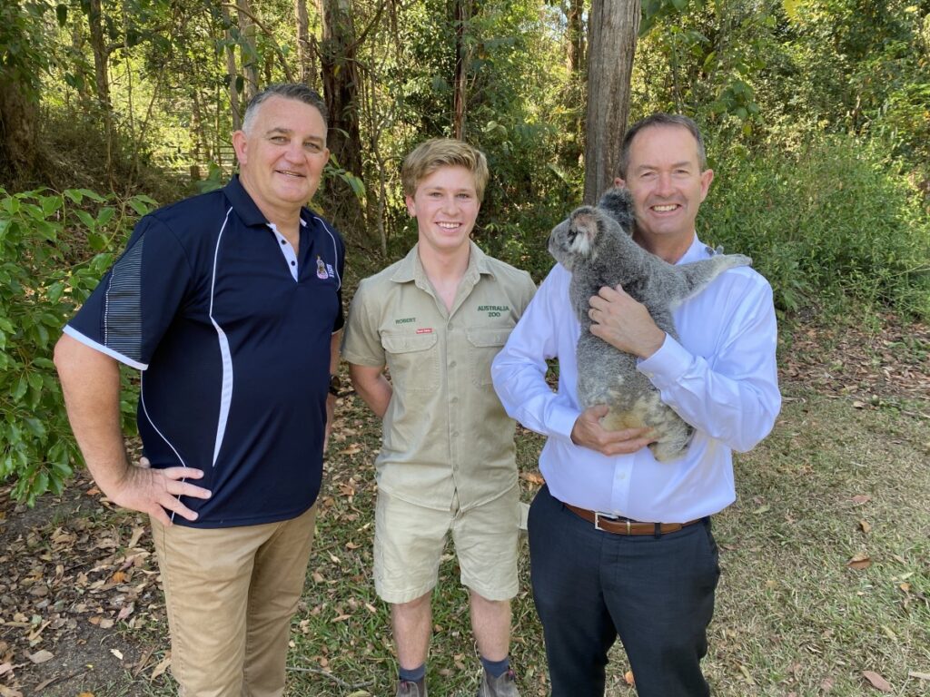 Andrew Wallace MP with Robert Irwin and Peter Kennedy of Young Veterans Sunshine Coast at Australia Zoo with a Koala